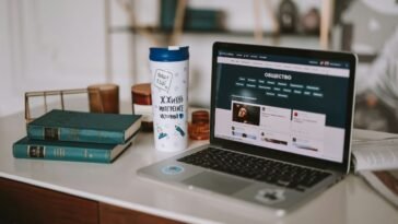 Illustration of a laptop displaying a blog page with various topics, representing top versatile blogs to follow in 2025.